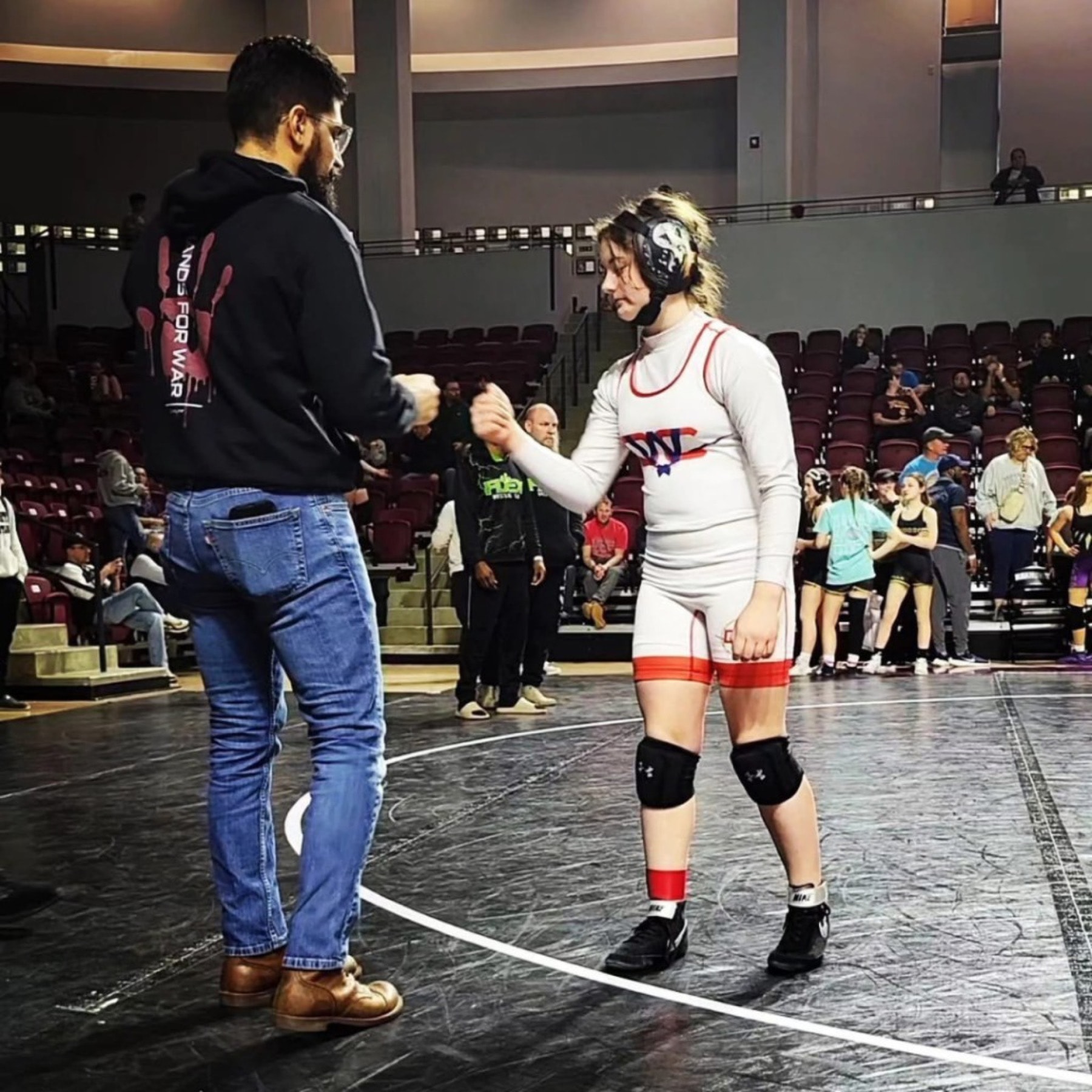 Hands for War fist bump before a match